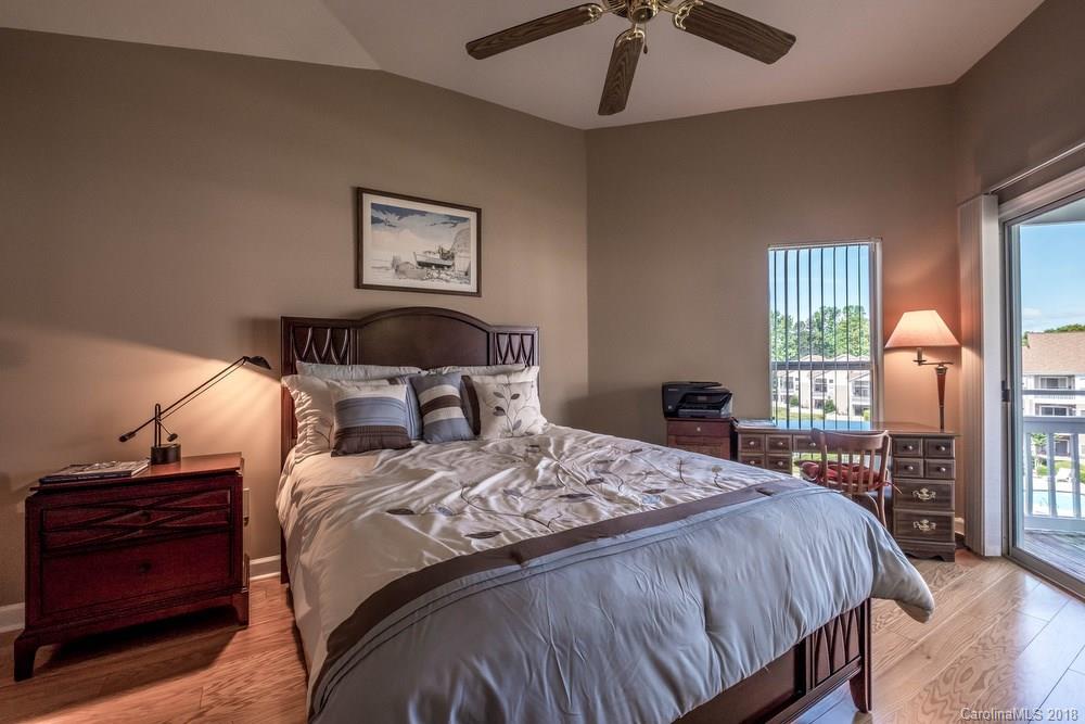 1115 Torrence Circle, Unit 63 Davidson, NC 28036 - Photo 12 of 23 a bedroom with bed and wooden floor