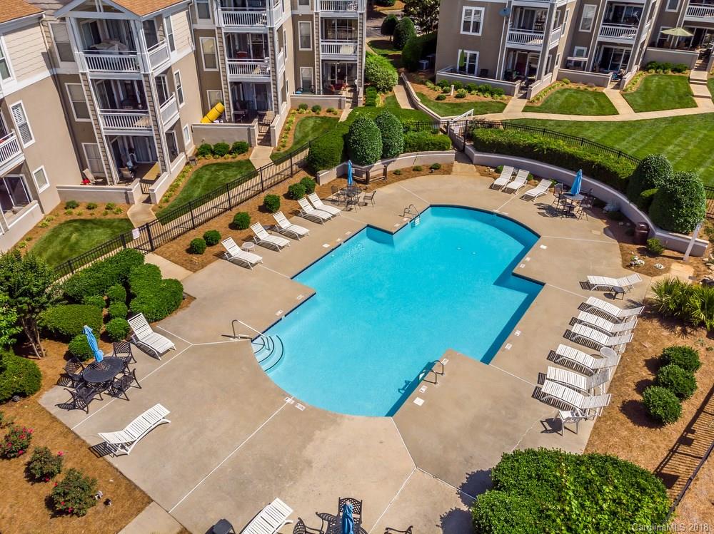 1115 Torrence Circle, Unit 63 Davidson, NC 28036 - Photo 19 of 23 a view of a swimming pool with outdoor seating and plants