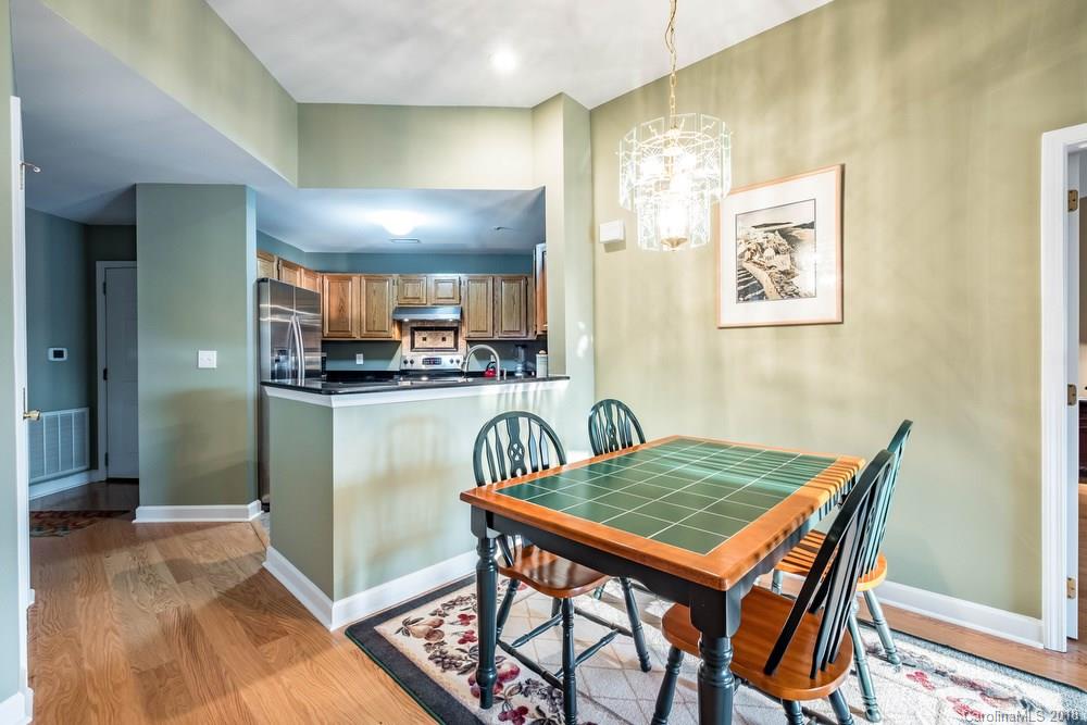 1115 Torrence Circle, Unit 63 Davidson, NC 28036 - Photo 8 of 23 a dining room with a granite table and chairs