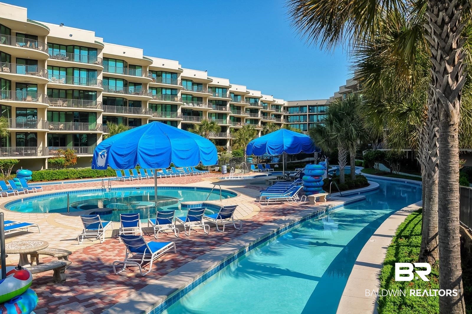 27580 Canal Road, Unit 1429 Orange Beach, AL 36561 - Photo 23 of 45 Community pool with a grill and a patio
