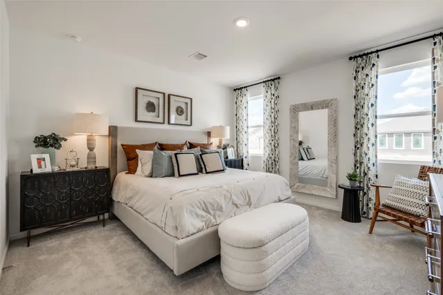 a spacious bedroom with a bed and a couch