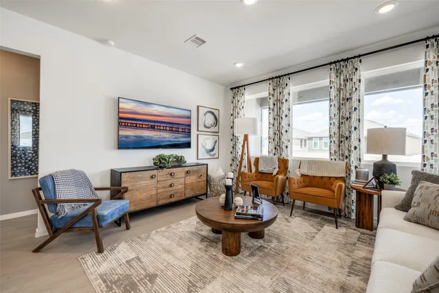 a living room with furniture and a large window
