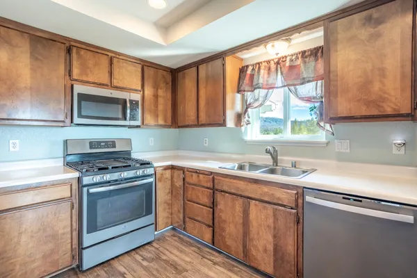 a kitchen with a sink stove top oven and cabinets