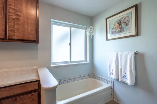 a bathroom with a bathtub and a window