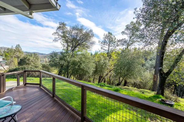 a view of a house with a yard patio and a garden
