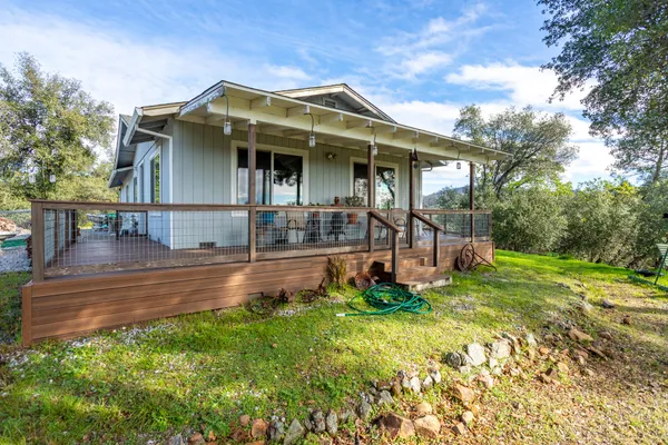 a view of balcony with wooden floor and fence