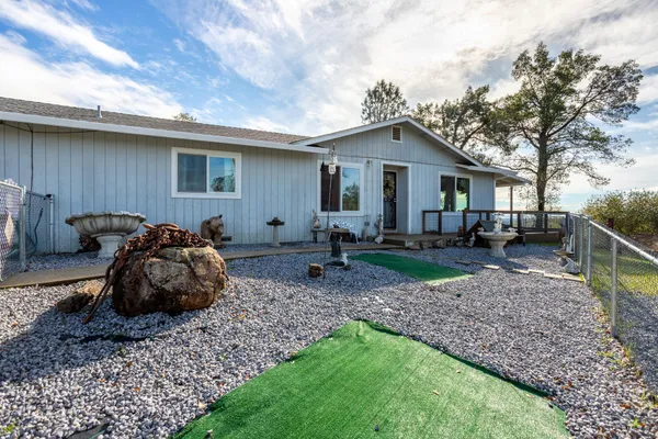 a view of a house with swimming pool and sitting area