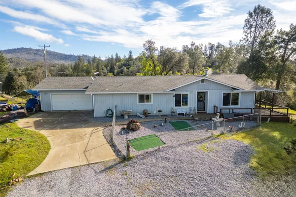 an aerial view of a house with a yard swimming pool and outdoor seating