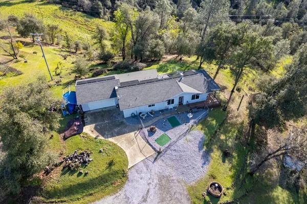 an aerial view of residential houses with yard
