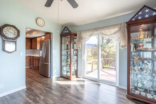 a view of a hallway with wooden floor and a chandelier