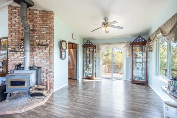 a view of an livingroom with furniture wooden floor chandelier and windows
