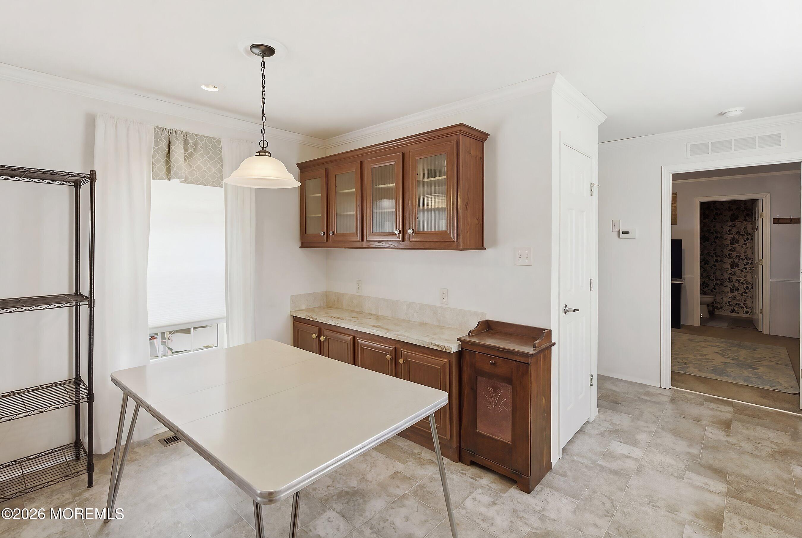 511 Sykesville Road, Unit 116 Wrightstown, NJ 08562 - Photo 2 of 14 a kitchen that has a cabinets and a table in it