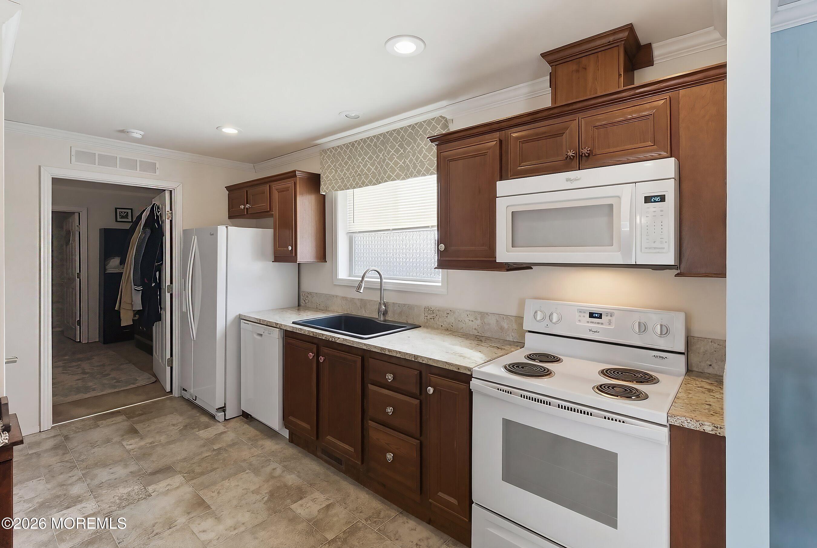 511 Sykesville Road, Unit 116 Wrightstown, NJ 08562 - Photo 3 of 14 a kitchen with stainless steel appliances granite countertop a stove and a microwave