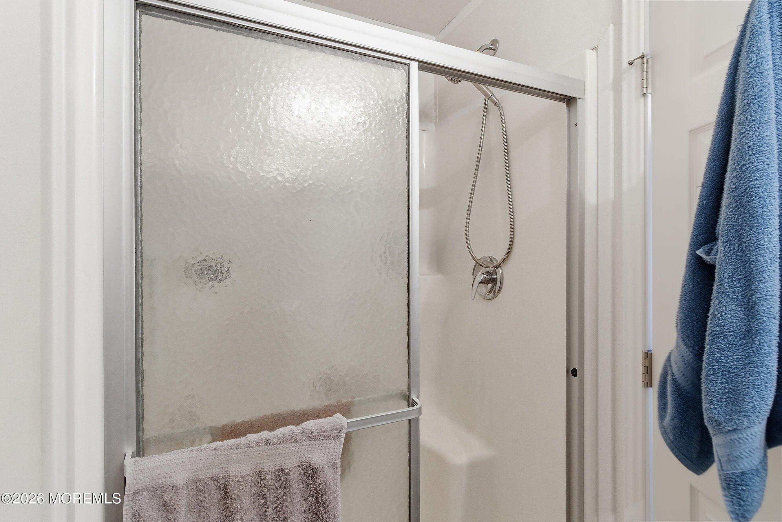 511 Sykesville Road, Unit 116 Wrightstown, NJ 08562 - Photo 5 of 14 a bathroom with a glass shower door