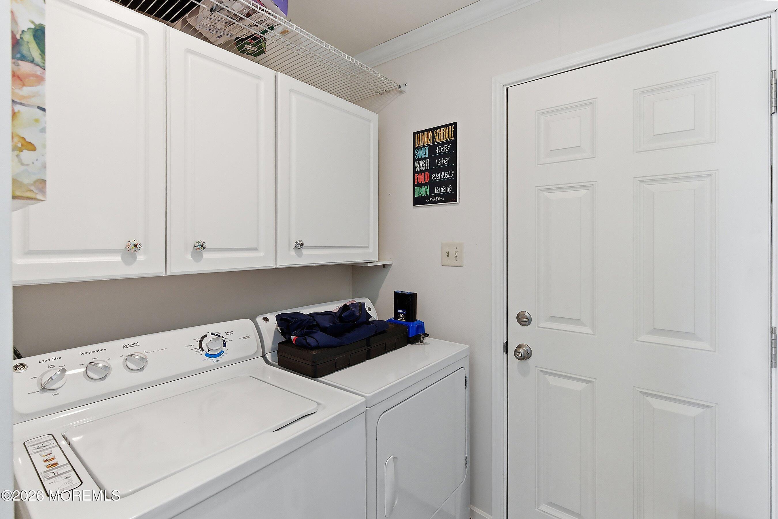 511 Sykesville Road, Unit 116 Wrightstown, NJ 08562 - Photo 6 of 14 a view of a storage and utility room with washer and dryer