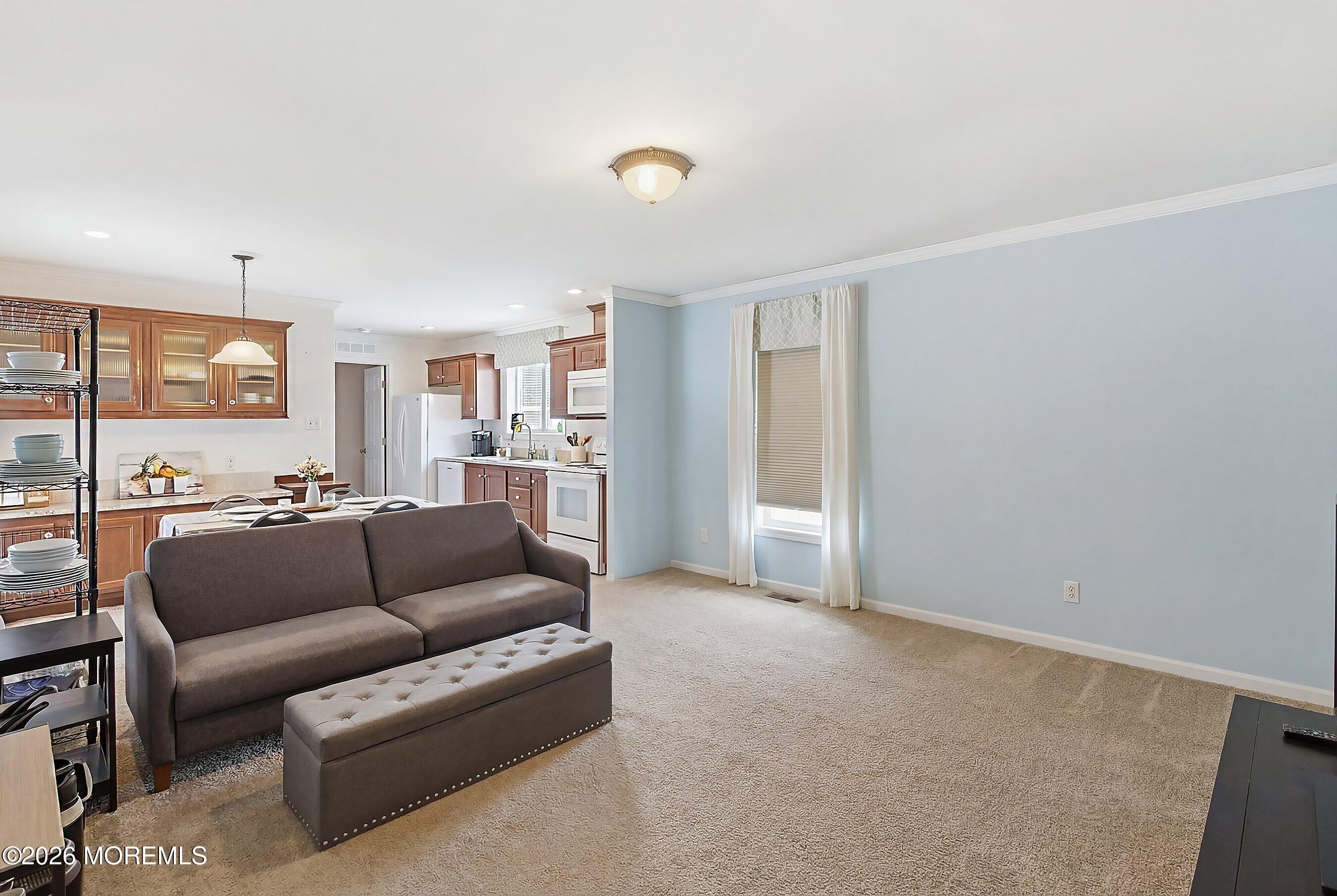 511 Sykesville Road, Unit 116 Wrightstown, NJ 08562 - Photo 9 of 14 a living room with furniture and a window