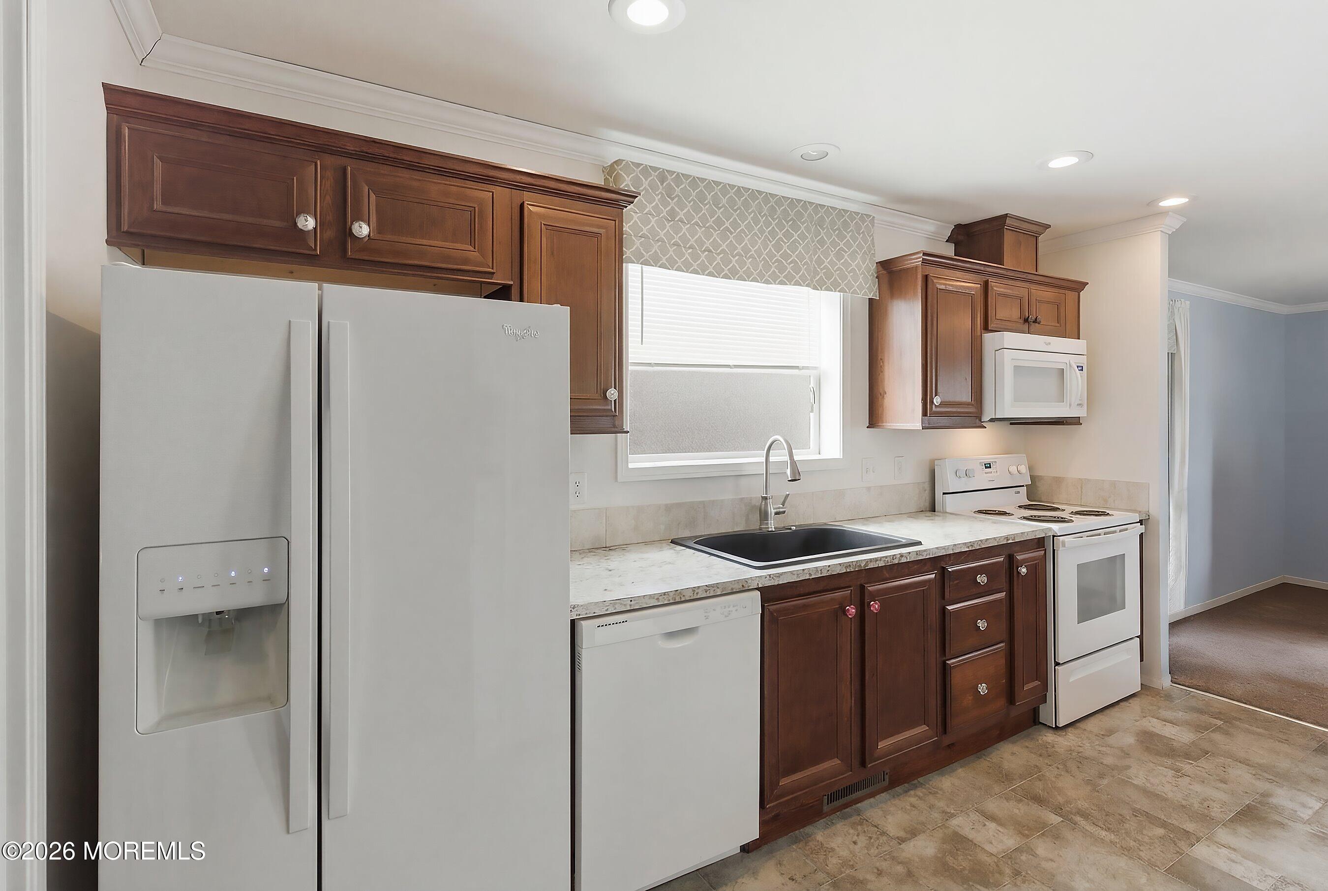 511 Sykesville Road, Unit 116 Wrightstown, NJ 08562 - Photo 10 of 14 a view of a sink a mirror and cabinets