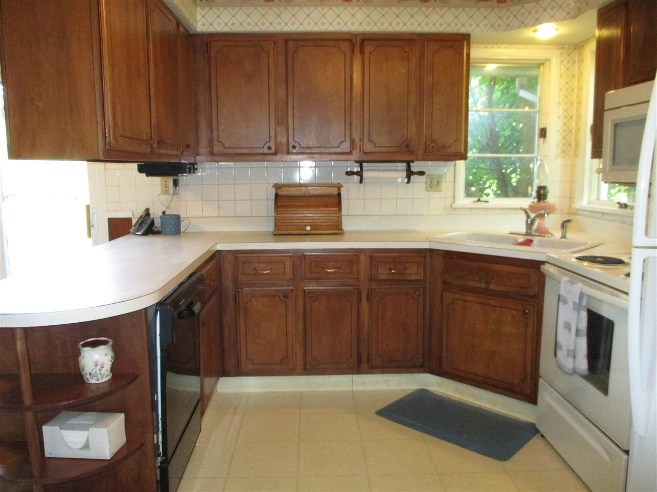 10641 Cemetery Road Pecatonica, IL 61063 - Photo 10 of 25 a kitchen with stainless steel appliances granite countertop a sink stove and microwave