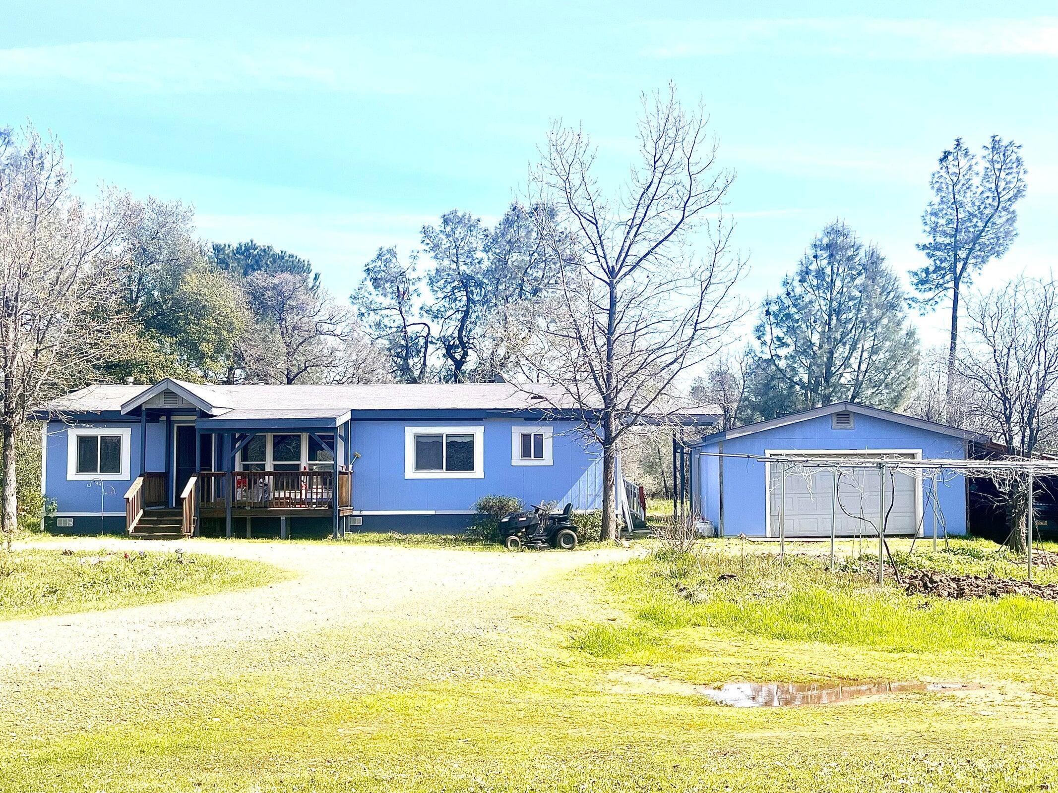 a front view of house with yard and lake view
