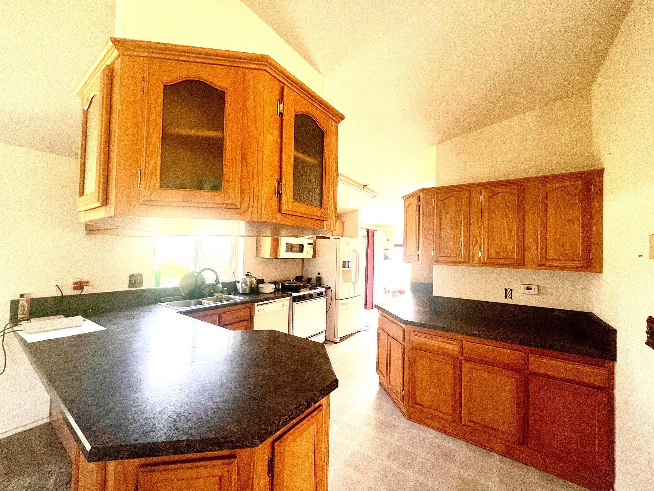 5321 Pine Street Anderson, CA 96007 - Photo 5 of 49 a kitchen with stainless steel appliances granite countertop a sink dishwasher and cabinets with wooden floor