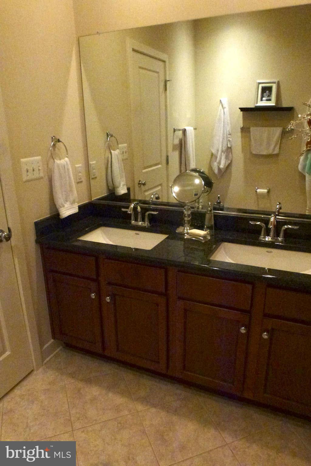 4159 Rush Street Fairfax, VA 22033 - Photo 16 of 30 a bathroom with a granite countertop sink and a mirror