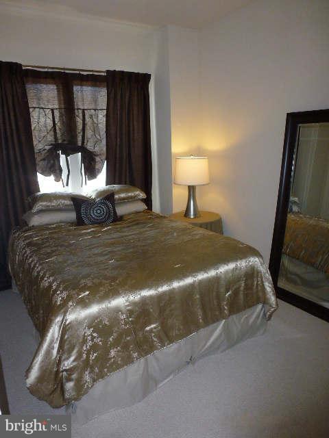 4159 Rush Street Fairfax, VA 22033 - Photo 17 of 30 a bed sitting in a bedroom next to a window