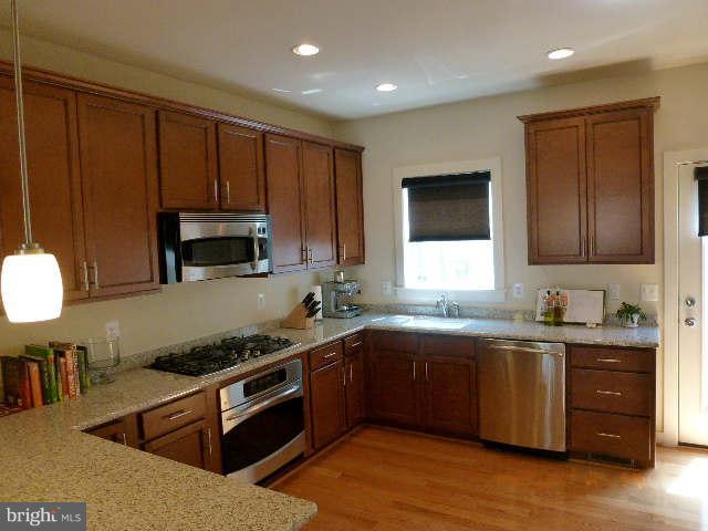 4159 Rush Street Fairfax, VA 22033 - Photo 3 of 30 a kitchen with stainless steel appliances granite countertop a sink stove and microwave