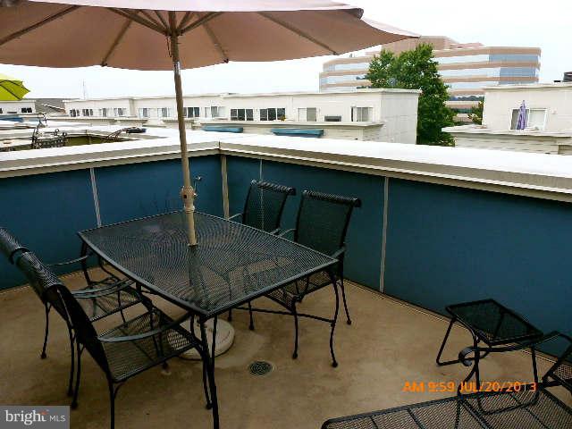 4159 Rush Street Fairfax, VA 22033 - Photo 27 of 30 a roof deck with table and chairs under an umbrella