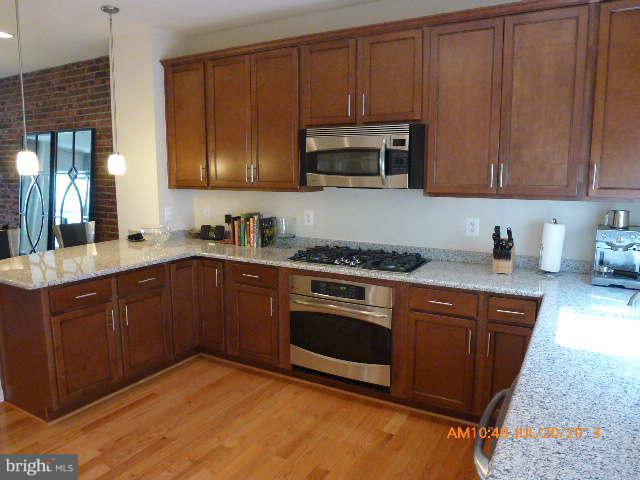 4159 Rush Street Fairfax, VA 22033 - Photo 4 of 30 a kitchen with stainless steel appliances granite countertop wooden cabinets a stove top oven a sink and dishwasher