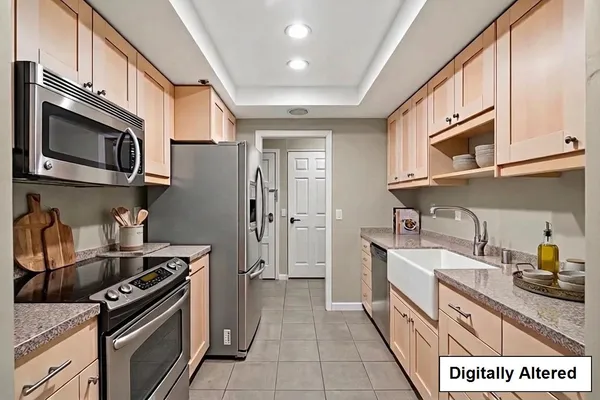 a kitchen with stainless steel appliances granite countertop a stove and cabinets