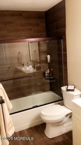 a bathroom with a toilet and a mirror