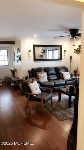 a living room with furniture a rug and a window