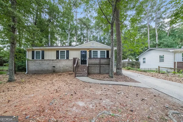 a front view of a house with a yard and balcony