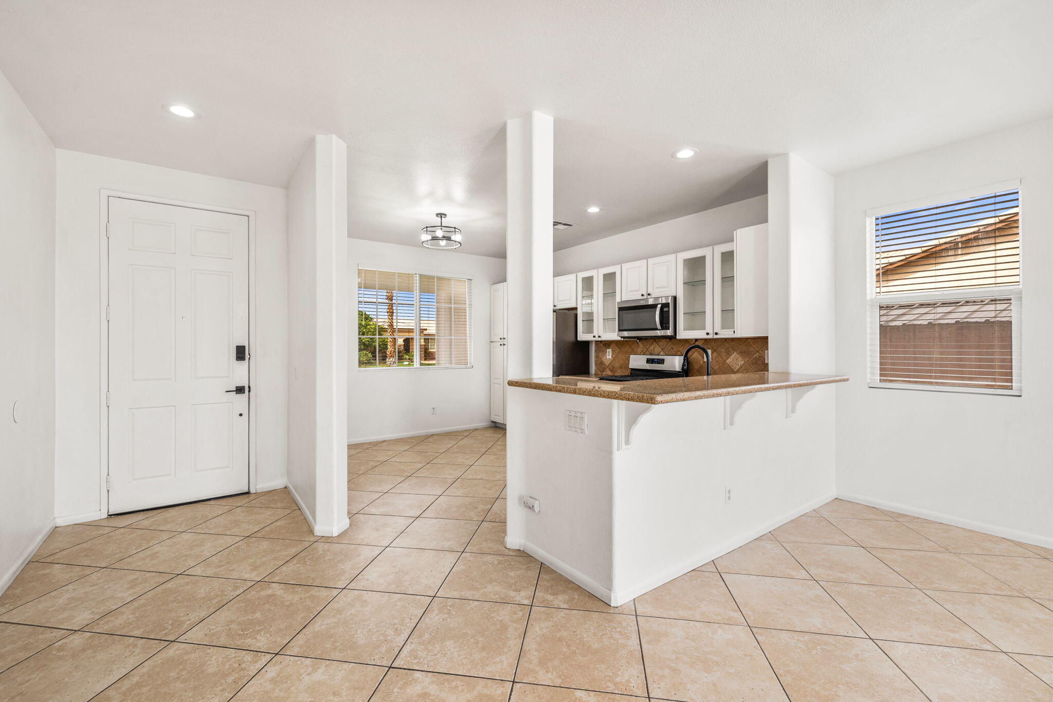 47558 Bison Circle Indio, CA 92201 - Photo 11 of 38 a kitchen with stainless steel appliances a refrigerator sink and cabinets
