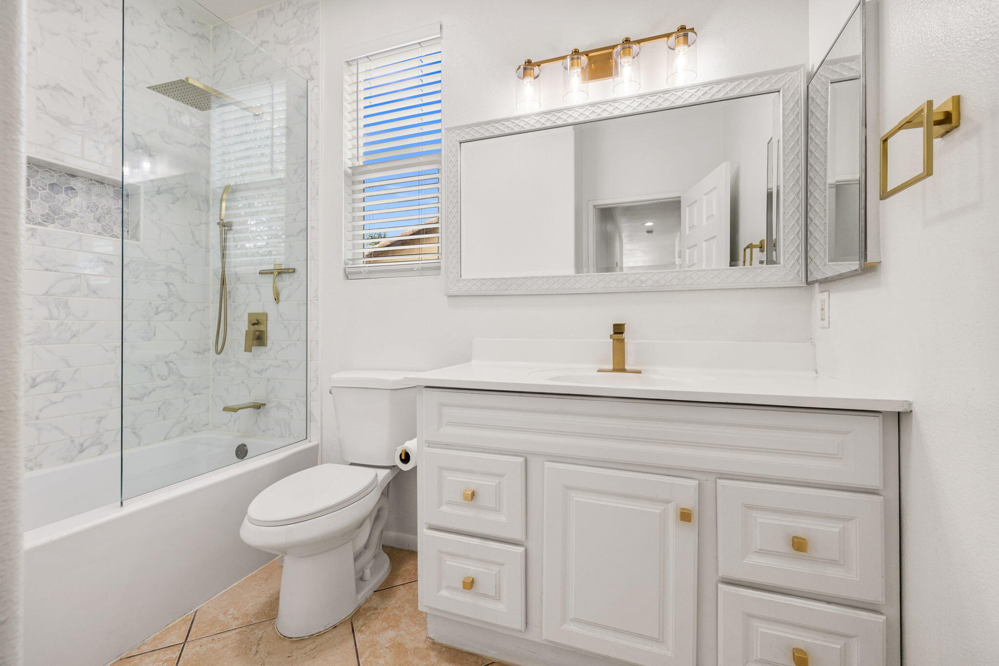 47558 Bison Circle Indio, CA 92201 - Photo 20 of 38 a bathroom with a toilet sink a mirror and shower
