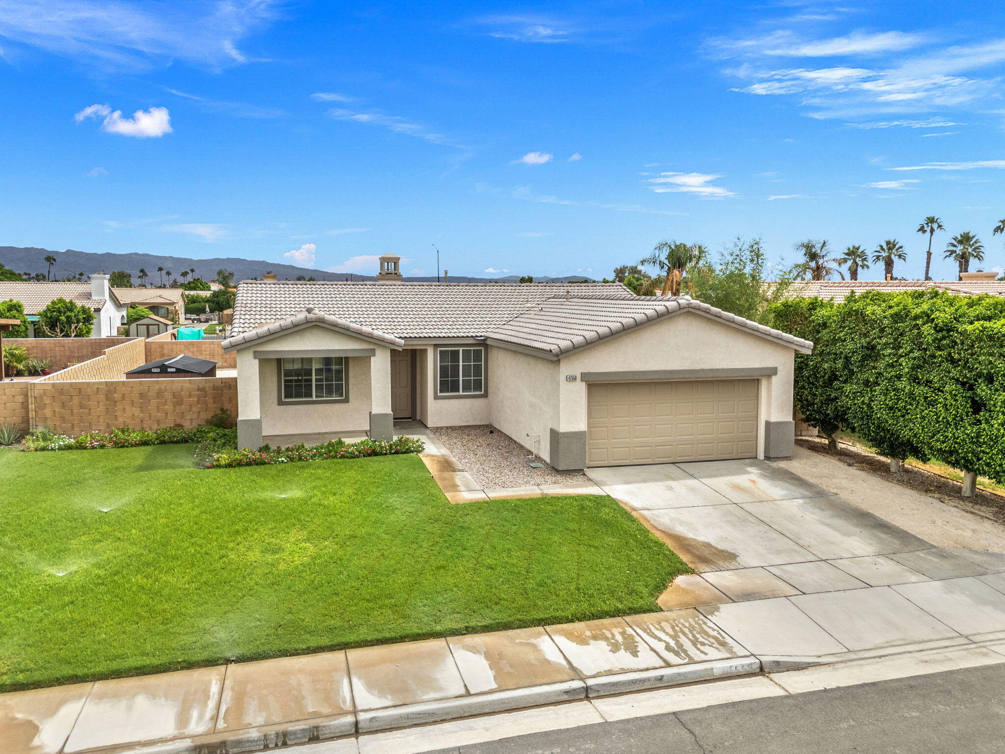 47558 Bison Circle Indio, CA 92201 - Photo 34 of 38 a front view of a house with a yard and garage