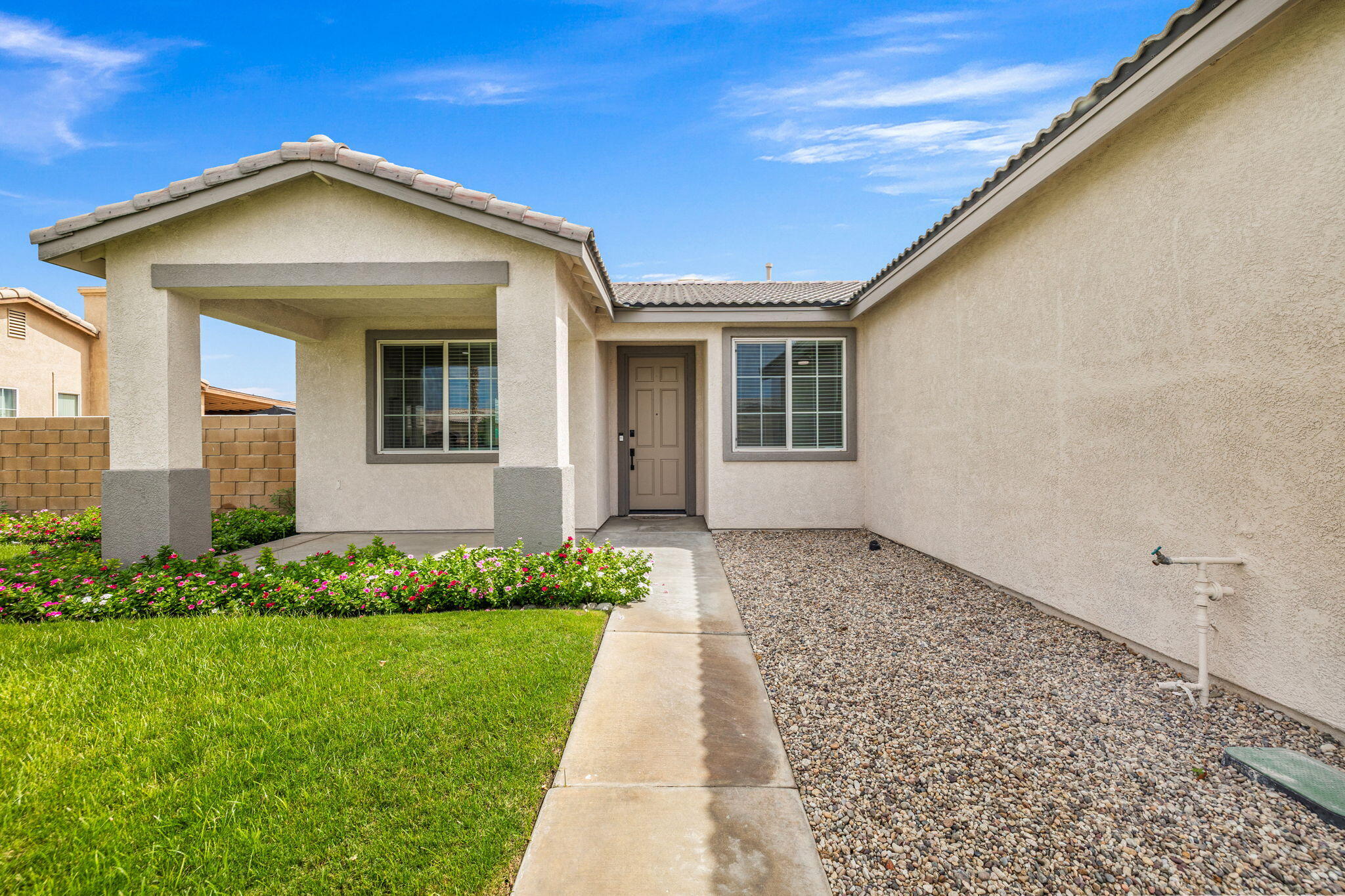 47558 Bison Circle Indio, CA 92201 - Photo 7 of 38 a front view of a house with a yard