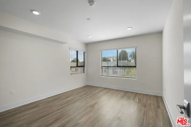 a view of a room with wooden floor and window