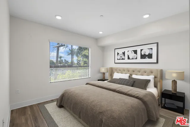 a bedroom with a large bed and a window