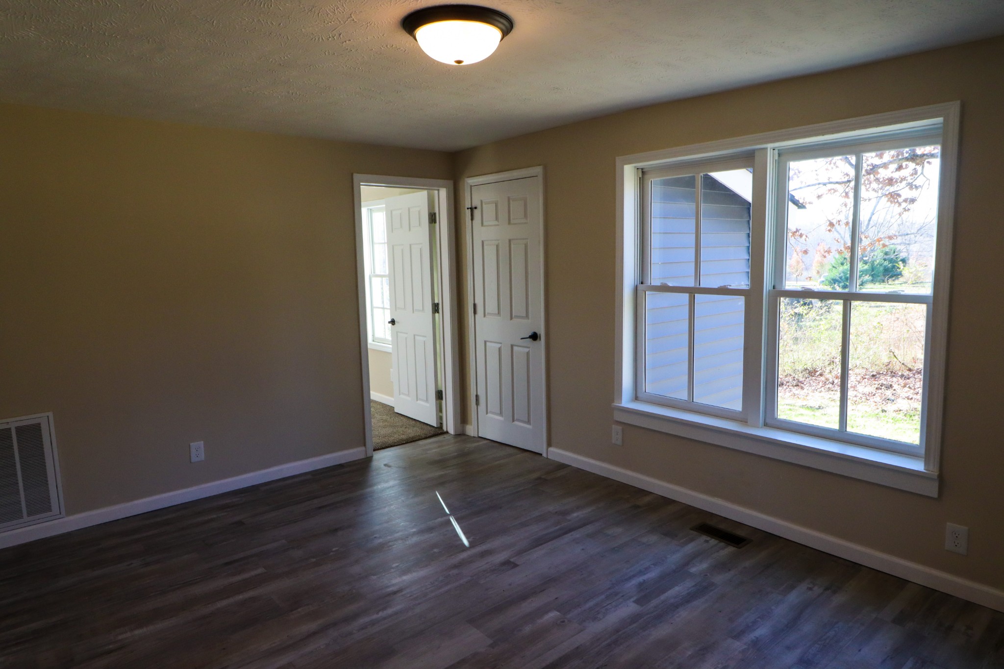 275 Telegraph Street Tennessee Ridge, TN 37178 - Photo 9 of 24 an empty room with wooden floor and windows