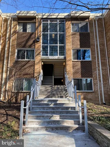 a view of front door of house with stairs