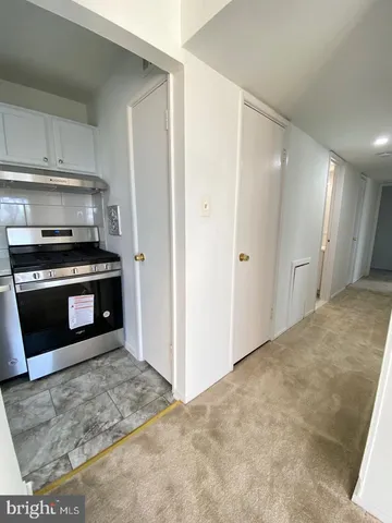 a kitchen with stainless steel appliances granite countertop a stove and a refrigerator