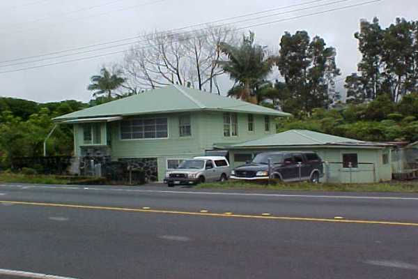 18-1190 Volcano Road Mountain View, HI 96771 - Photo 1 of 18 a front view of a house with a garden and plants