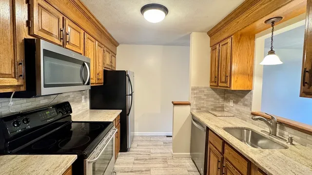 a kitchen with a sink stove and microwave