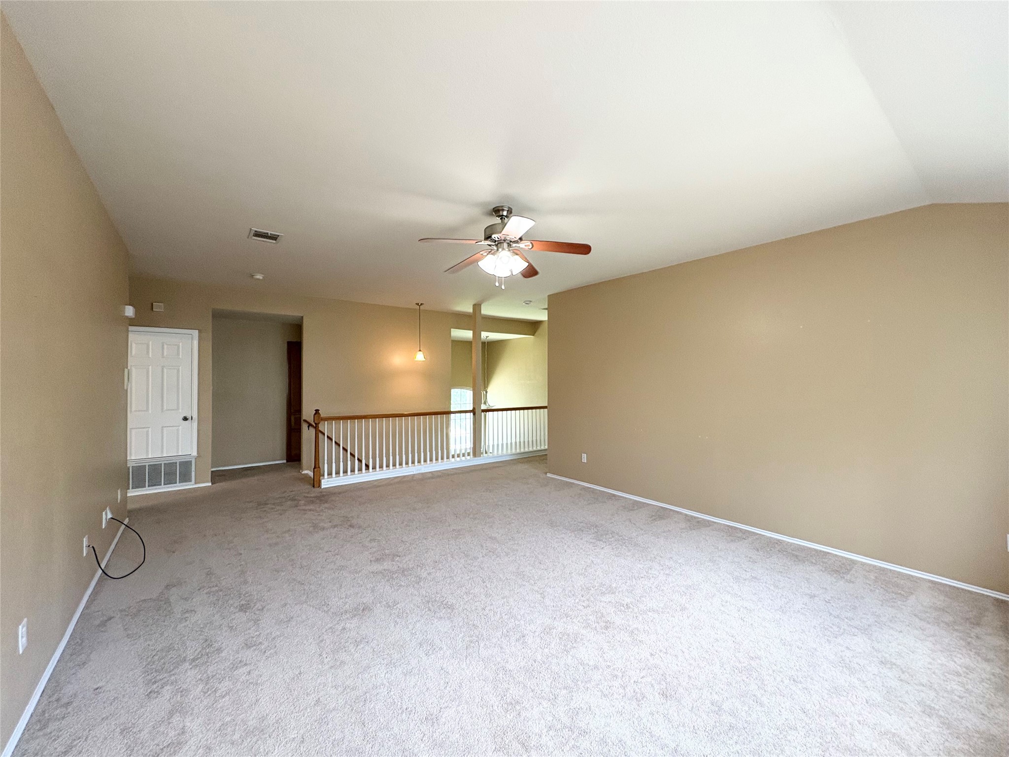 8103 Ephraim Road Austin, TX 78717 - Photo 18 of 35 A versatile open space with carpeted floors and a ceiling fan, perfect for adaptable living.