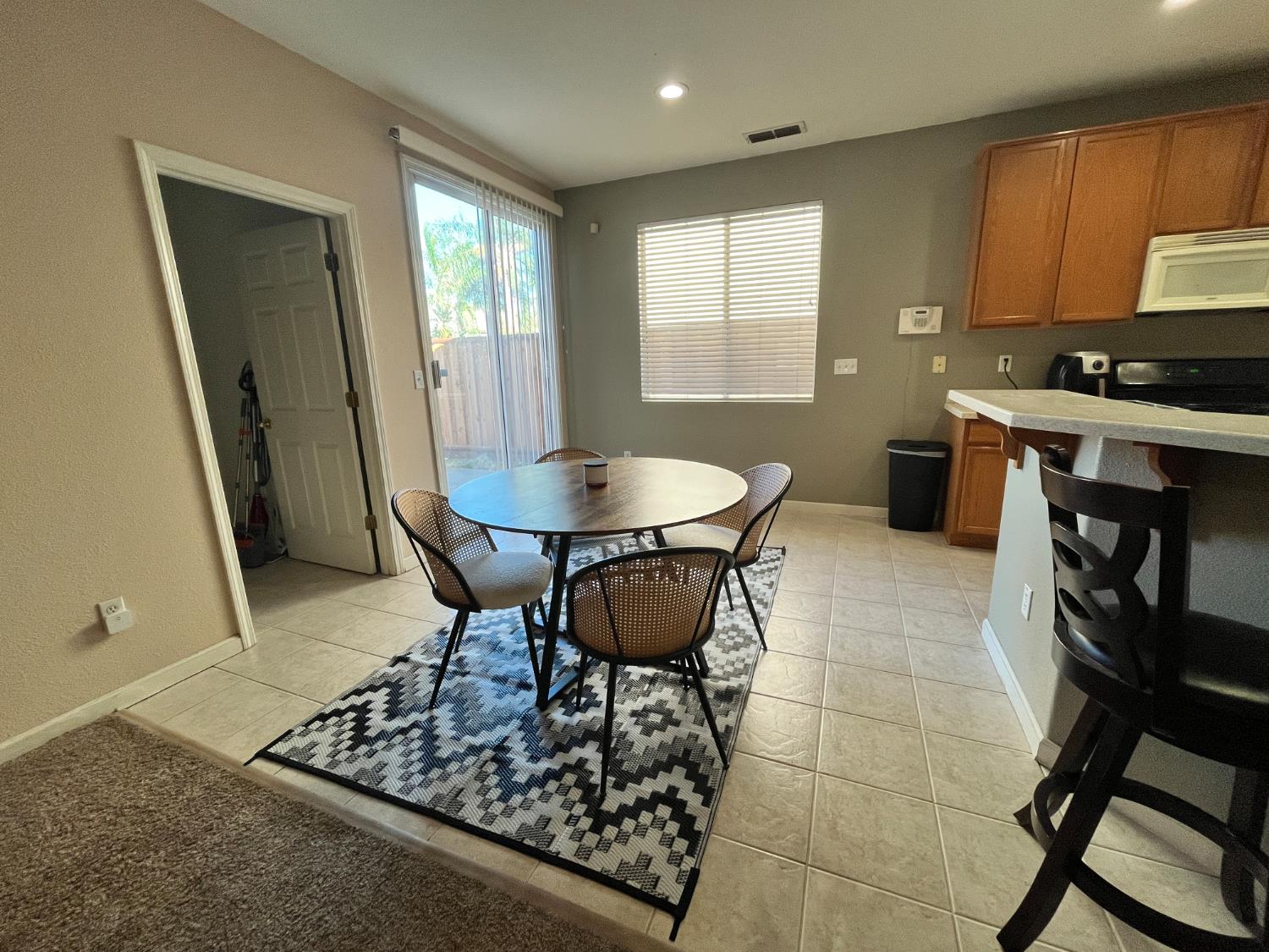 1117 Marsh Wren Court Patterson, CA 95363 - Photo 13 of 41 a living room with stainless steel appliances furniture a rug and a window