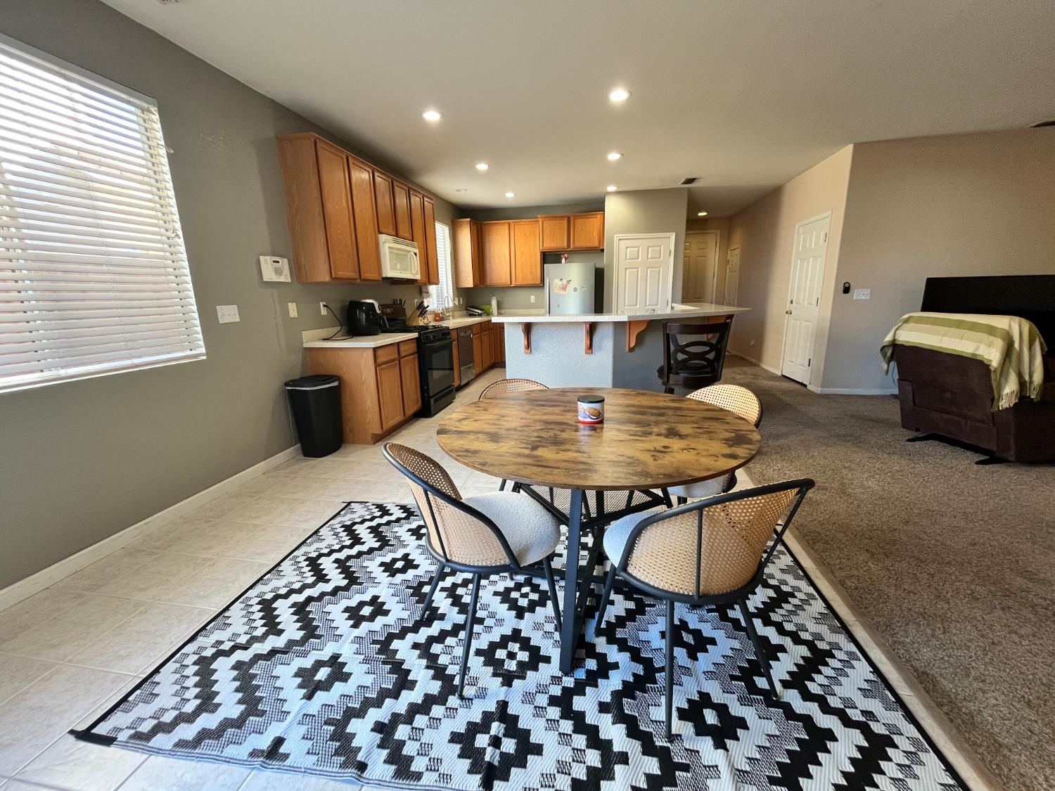 1117 Marsh Wren Court Patterson, CA 95363 - Photo 14 of 41 a open kitchen with a table and chairs in it