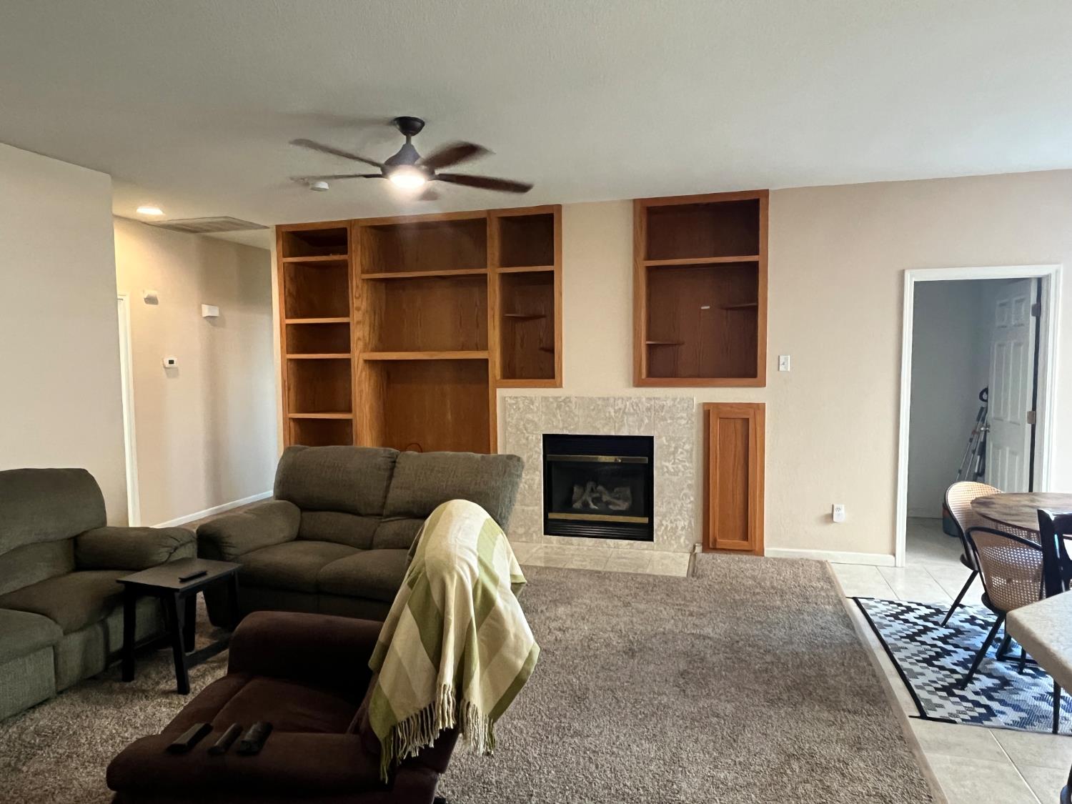 1117 Marsh Wren Court Patterson, CA 95363 - Photo 16 of 41 a living room with furniture windows and a fireplace
