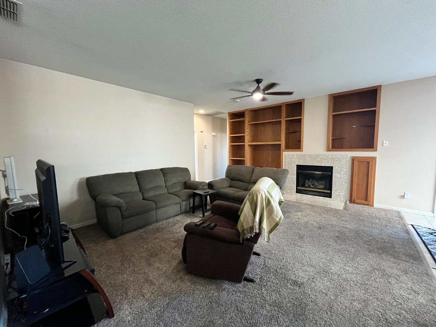 1117 Marsh Wren Court Patterson, CA 95363 - Photo 17 of 41 a living room with furniture and a fireplace