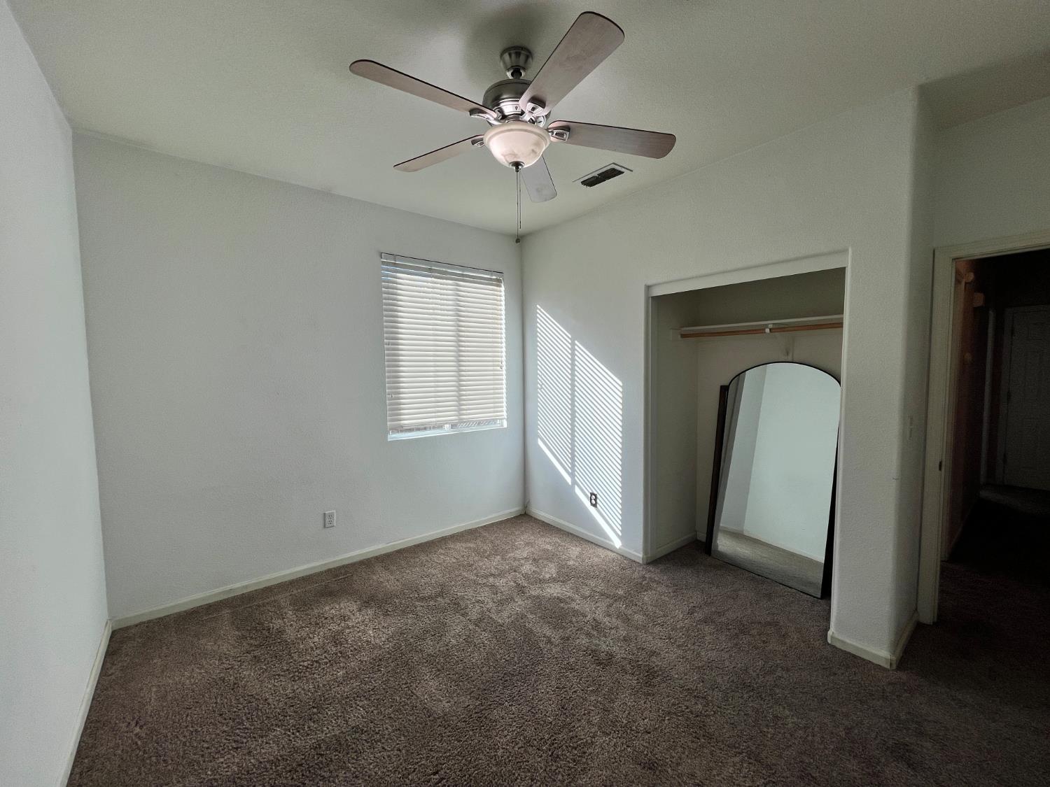 1117 Marsh Wren Court Patterson, CA 95363 - Photo 25 of 41 a view of a livingroom with a ceiling fan and window